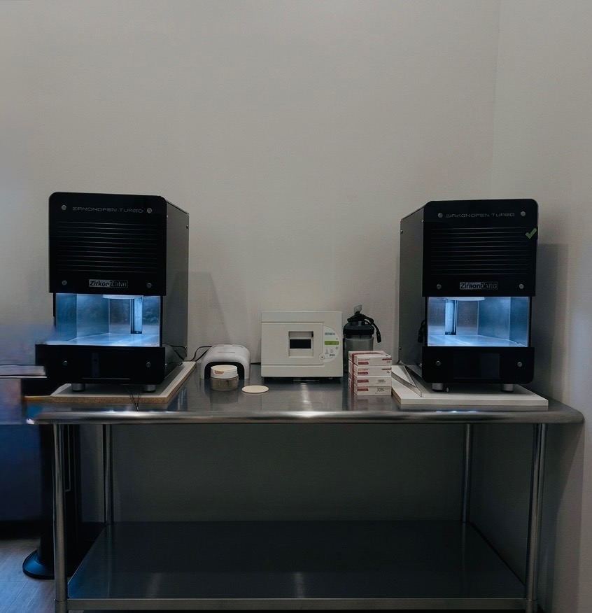Two dental sintering units and supporting laboratory equipment